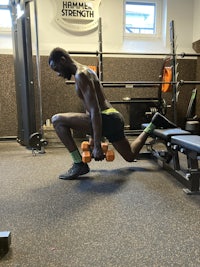 a man squatting in a gym