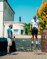 a man is doing a trick with a frisbee